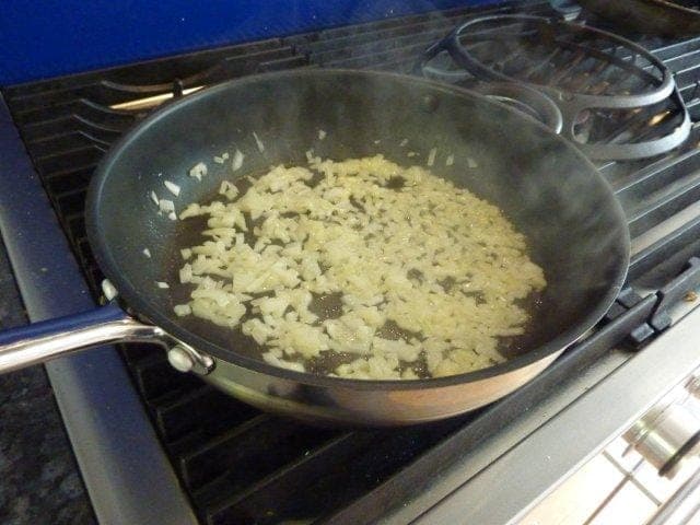 Finely chop a medium sized onion and saute in butter for a few minutes
